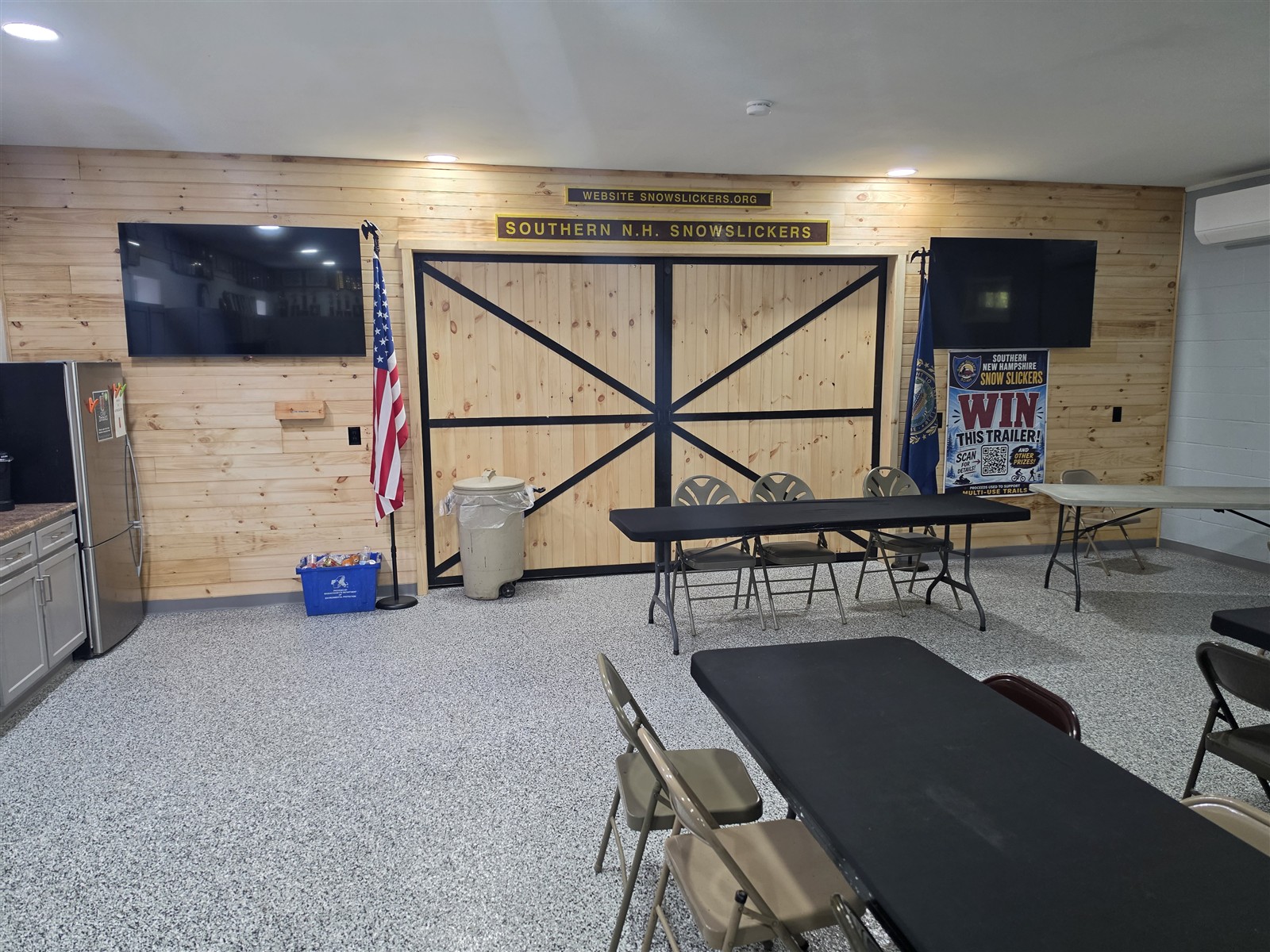 Wood barn-style doors with dark cross braces at the end of the meeting room.